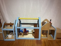 Handmade wooden dollhouse with people and furniture